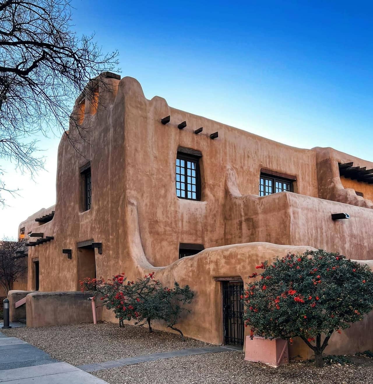 A Pueblo Revival home in Santa Fe under a blue sky