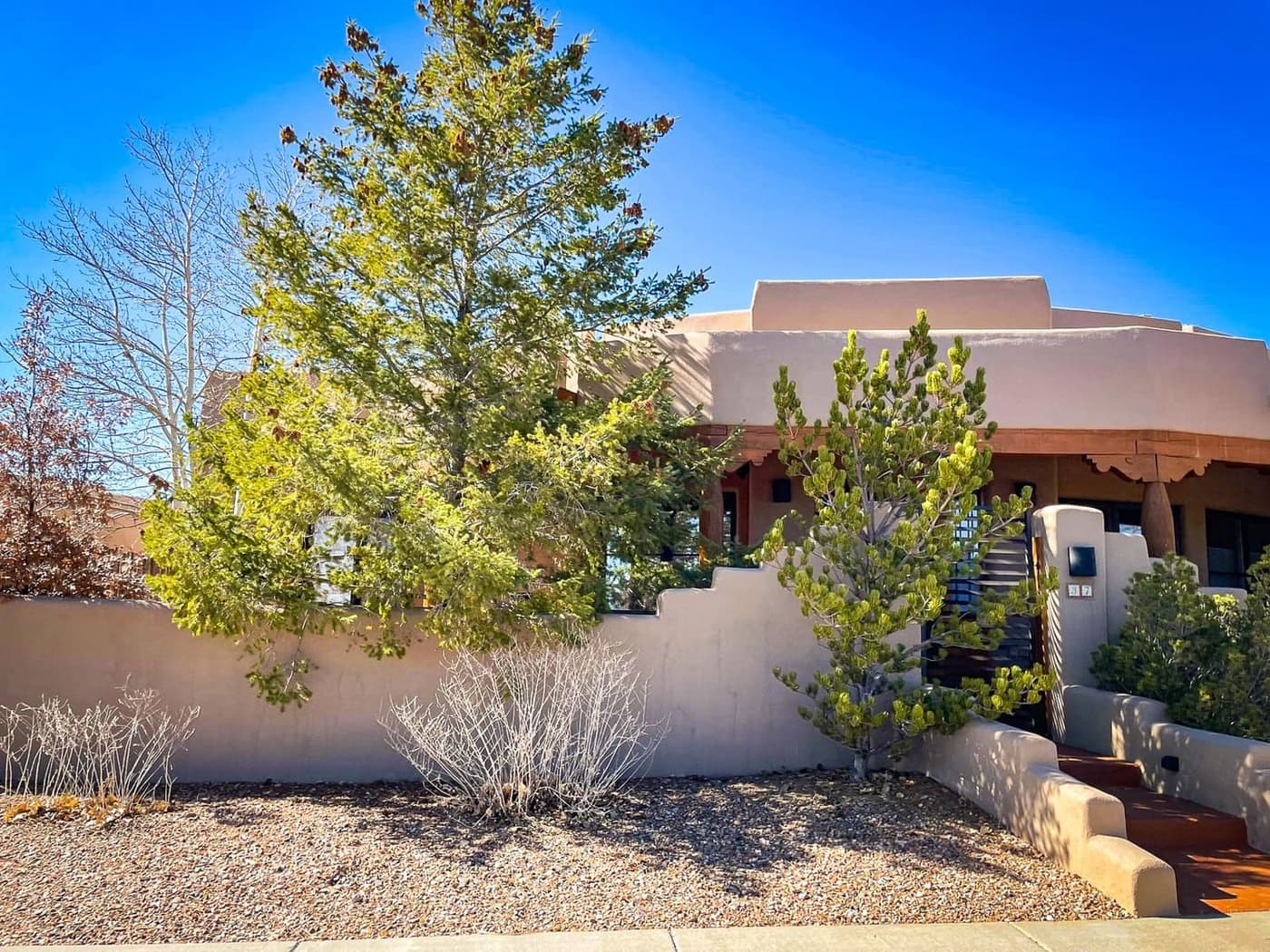 A Santa Fe adobe home behind its garden wall